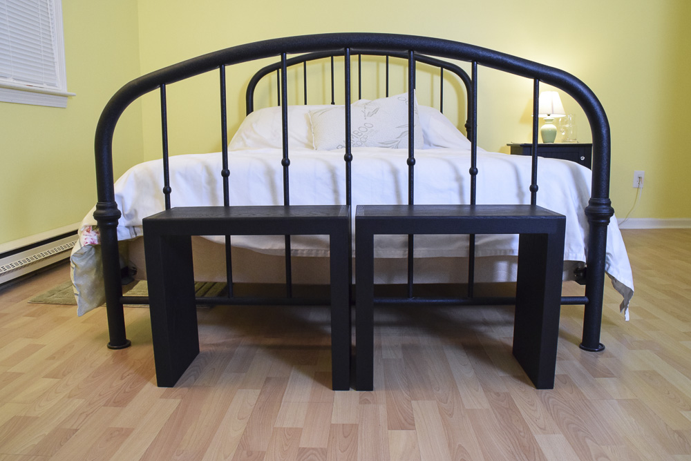 black oak sitting benches at end of bed