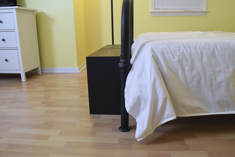 side view of black oak sitting benches at end of bed