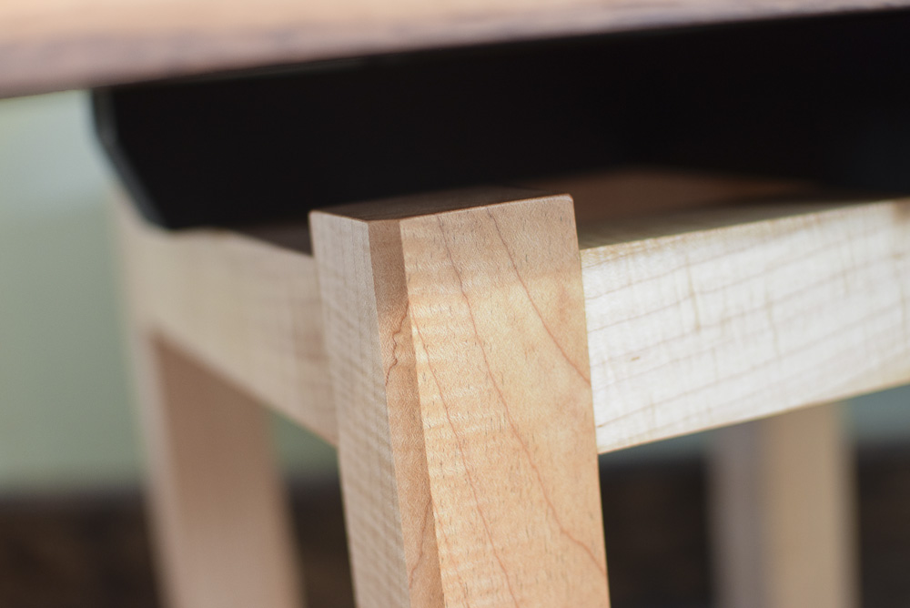 leg chamfer detail of the walnut and maple open end table