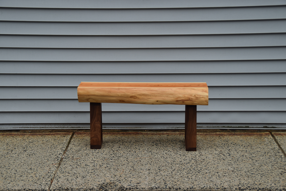 live edge yew bench with walnut legs viewed from the side