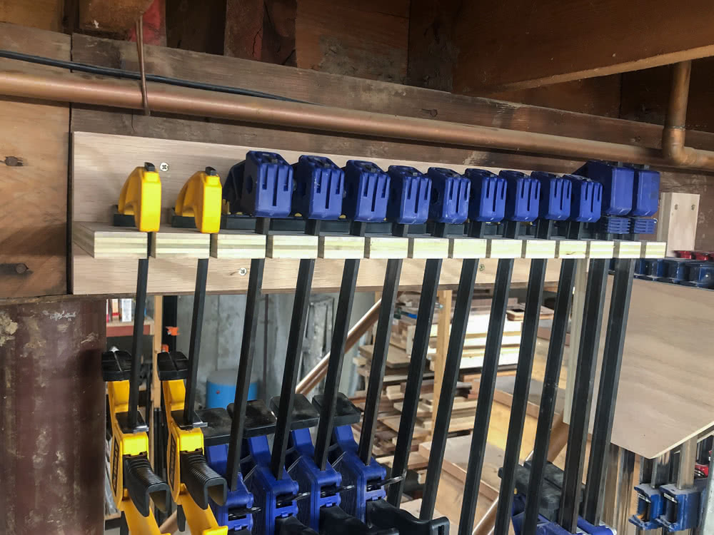 quick clamps hanging in the oak plywood quick clamp rack