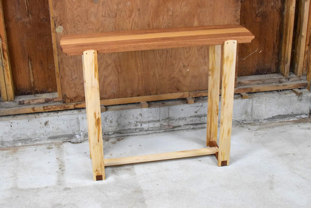 Angled view of Mahogany and Maple Console Table