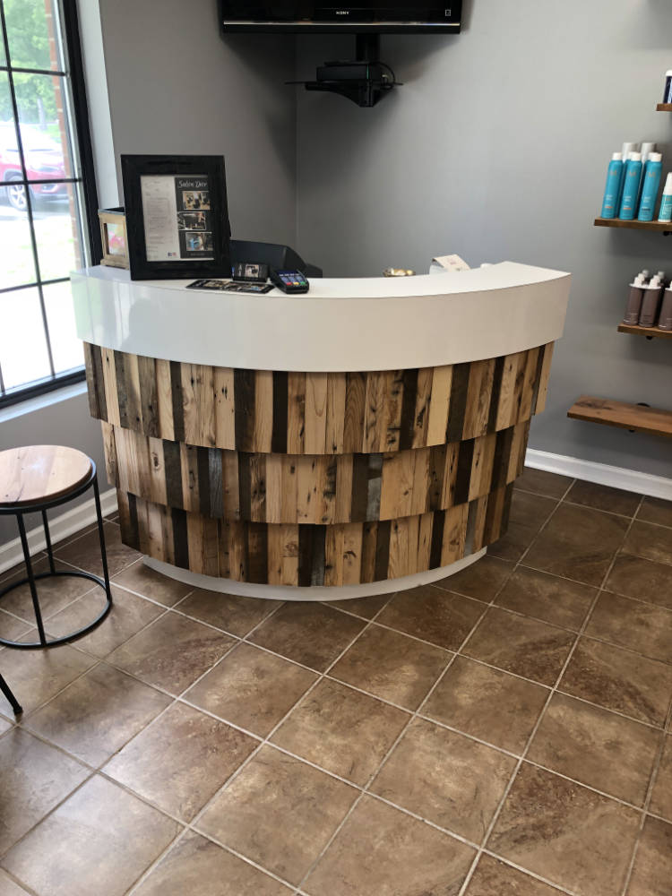 custom furniture. curved reception desk wrapped wrapped with wood planks