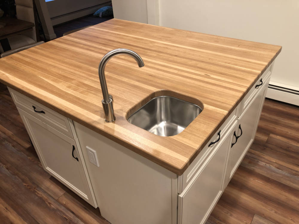 custom furniture. white oak island top with sink cutout