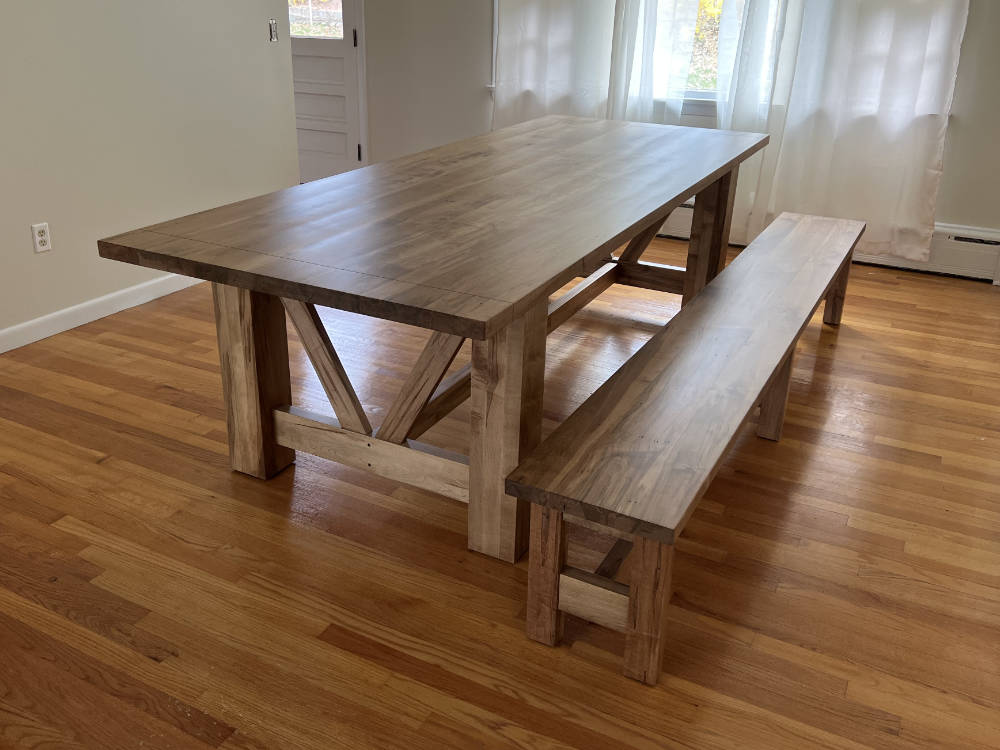 custom furniture. light brown farmhouse-style, wormy maple dining table and bench