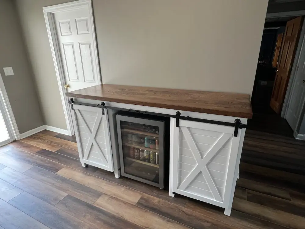 custom furniture. white painted double cabinet bar with sliding barn doors and brown maple top